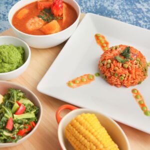 Flat lay of vibrant African dishes including jollof rice and vegetables, ideal for food presentations.